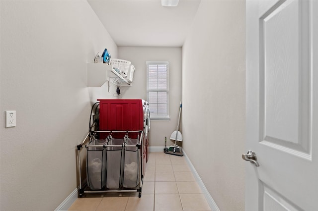 clothes washing area featuring washing machine and clothes dryer and light tile patterned floors