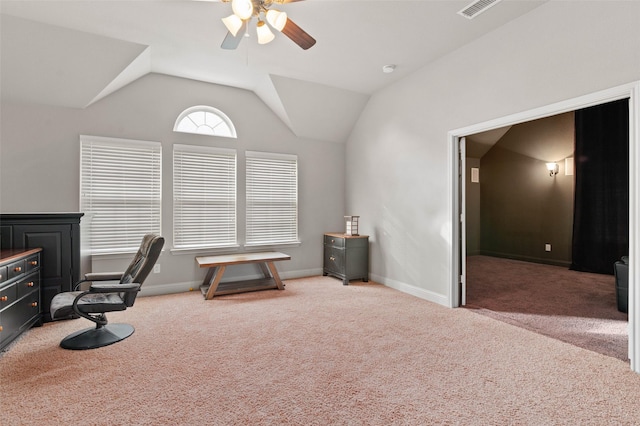 carpeted home office featuring lofted ceiling and ceiling fan