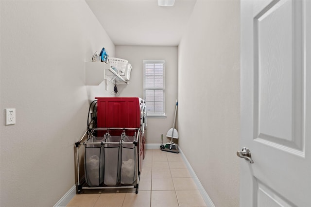 laundry room featuring baseboards, separate washer and dryer, laundry area, and light tile patterned floors