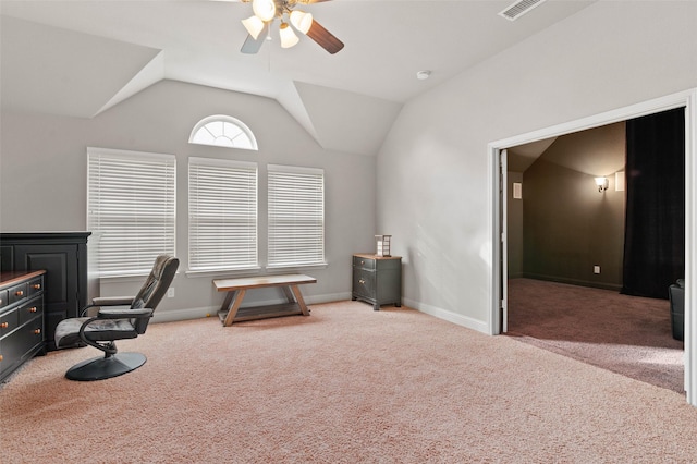 office space with vaulted ceiling, carpet, baseboards, visible vents, and ceiling fan