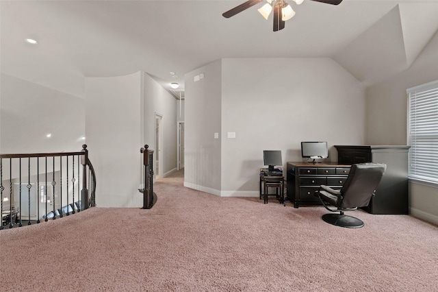 carpeted office space with a ceiling fan, baseboards, and vaulted ceiling