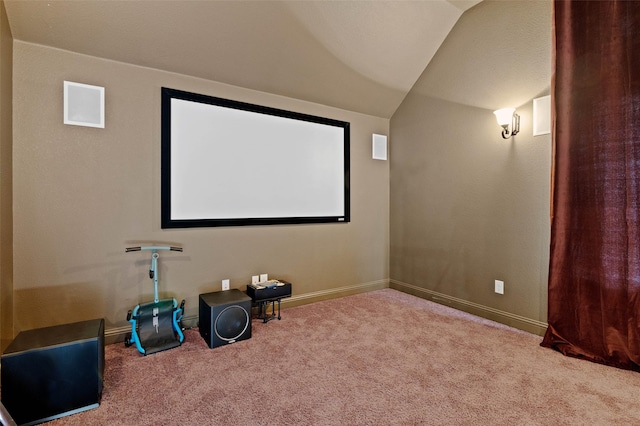 carpeted home theater room featuring baseboards and lofted ceiling