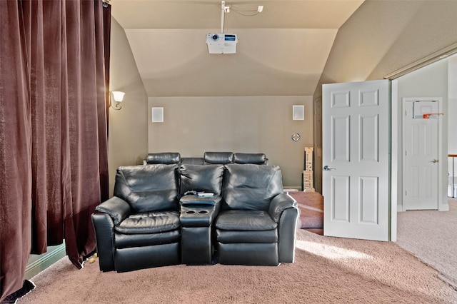 carpeted home theater with vaulted ceiling