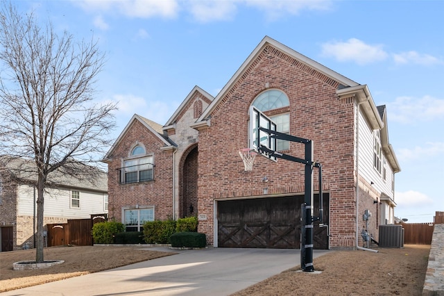 view of front property with a garage and central AC