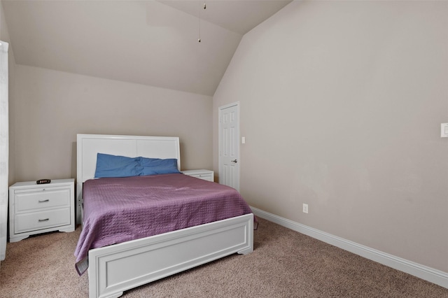 carpeted bedroom with baseboards and vaulted ceiling