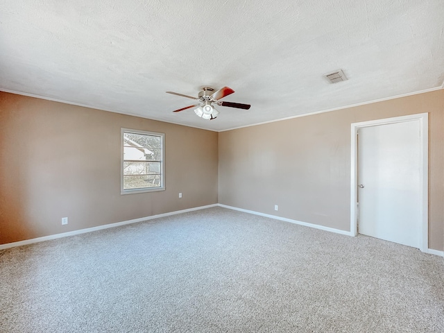 unfurnished room featuring visible vents, a textured ceiling, carpet flooring, crown molding, and ceiling fan