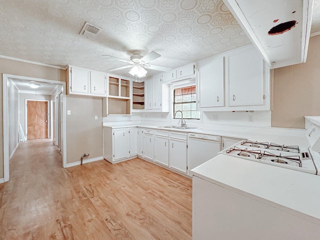 kitchen featuring visible vents, ceiling fan, a sink, light wood-style flooring, and dishwasher