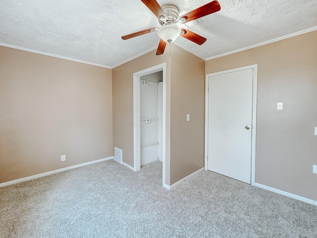 unfurnished bedroom with ceiling fan, a textured ceiling, visible vents, baseboards, and carpet