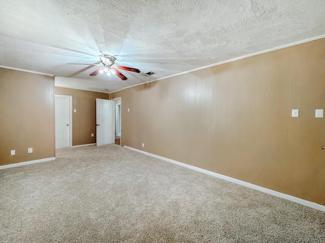 carpeted empty room with visible vents, baseboards, ornamental molding, a textured ceiling, and a ceiling fan