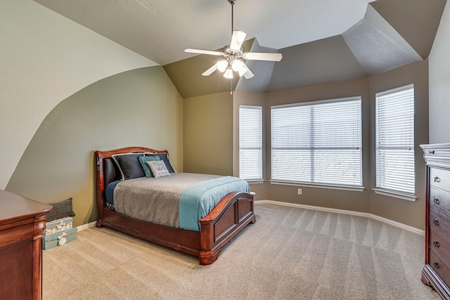 bedroom featuring vaulted ceiling, baseboards, a ceiling fan, and light colored carpet