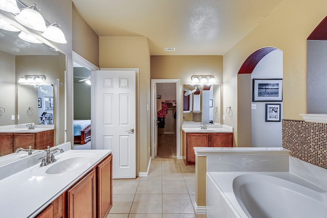 bathroom featuring a sink, visible vents, two vanities, and tile patterned floors