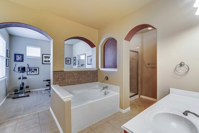 bathroom with vanity, a stall shower, tile patterned flooring, and a bath