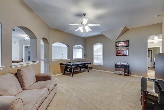 recreation room with light carpet, baseboards, a ceiling fan, and lofted ceiling