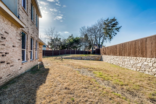 view of yard with a fenced backyard