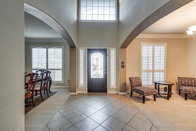 entrance foyer with plenty of natural light and crown molding