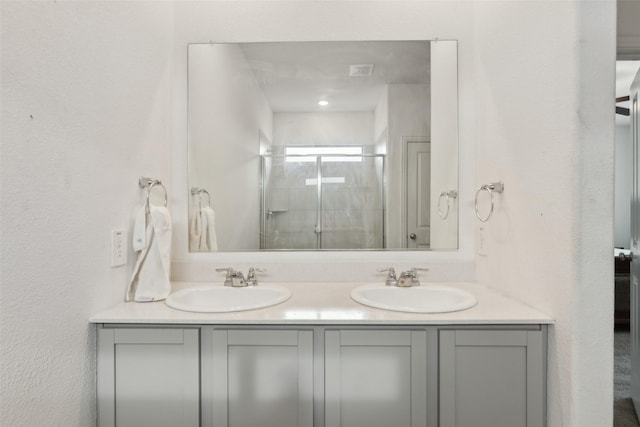 bathroom featuring vanity and an enclosed shower