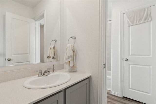 bathroom featuring hardwood / wood-style flooring and vanity