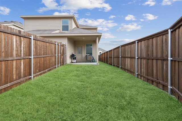 rear view of house with a patio and a yard