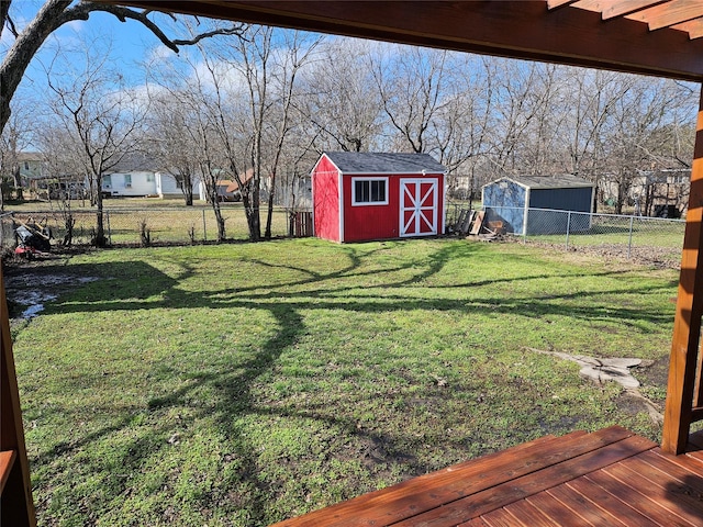 view of yard with a deck and a storage shed