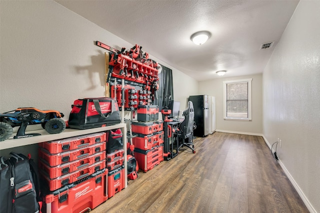 interior space with hardwood / wood-style floors and a textured ceiling