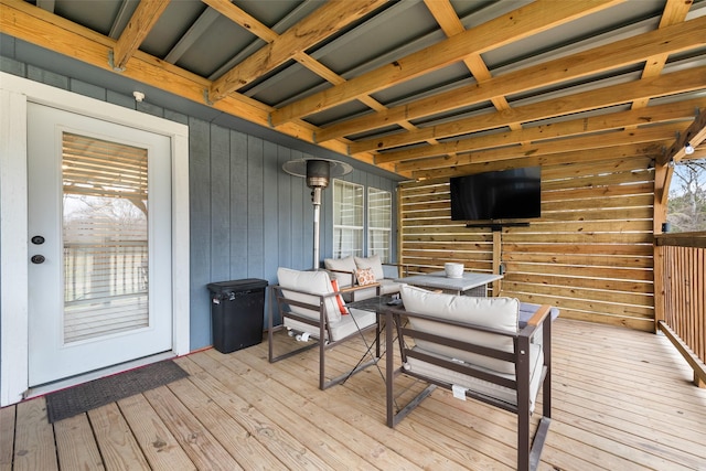 wooden deck with an outdoor living space