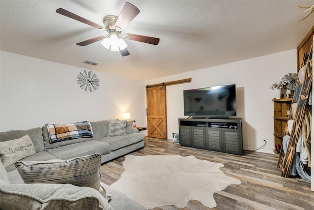 1714 Vz County Road 2142 Unit 2142, Wills Point, TX 75169 - living area featuring a barn door, wood finished floors, and ceiling fan
