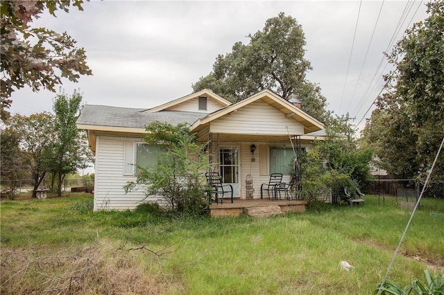 bungalow-style home with a front yard