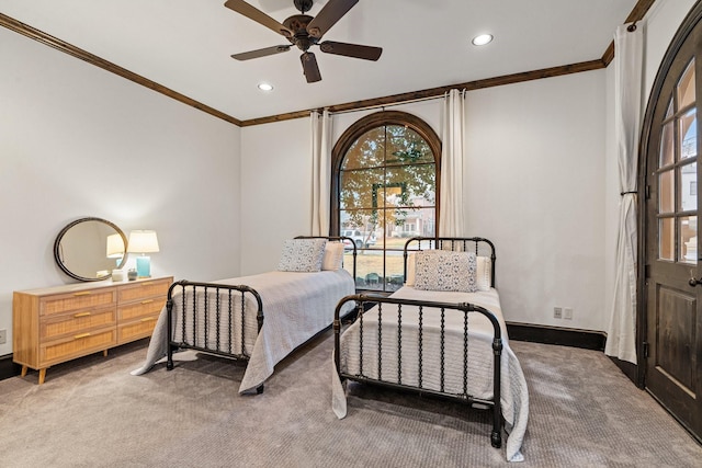 bedroom featuring crown molding, carpet flooring, and multiple windows