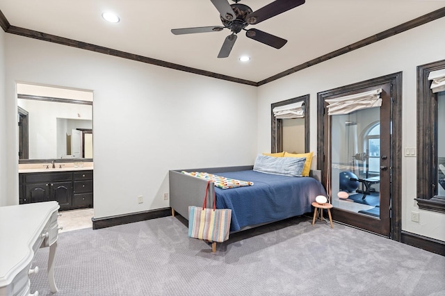 carpeted bedroom featuring ceiling fan, ornamental molding, connected bathroom, and sink