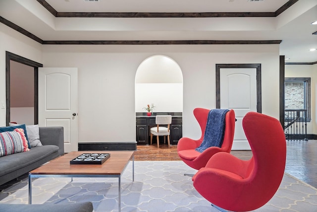 living room featuring arched walkways, baseboards, and crown molding