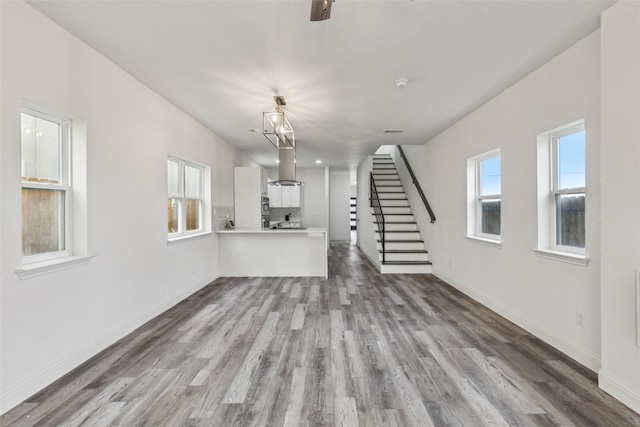 unfurnished living room with hardwood / wood-style flooring