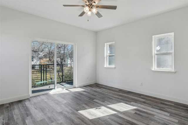 spare room featuring dark wood-type flooring and ceiling fan