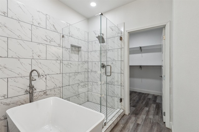 bathroom featuring wood-type flooring and independent shower and bath