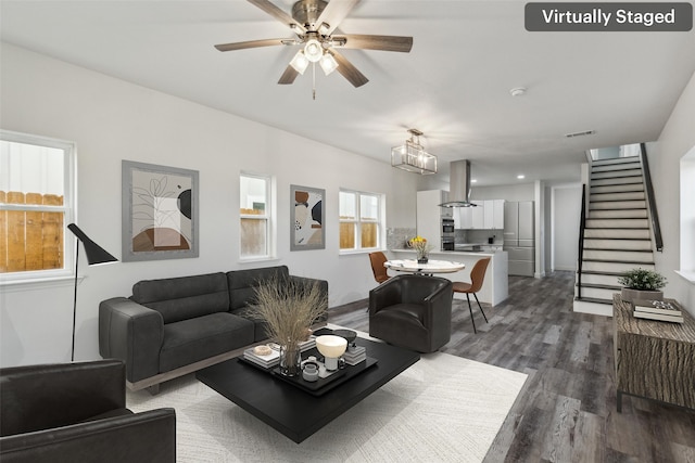 living room featuring dark wood-type flooring and ceiling fan