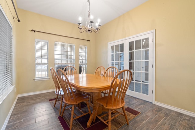 dining space featuring a notable chandelier and dark hardwood / wood-style floors