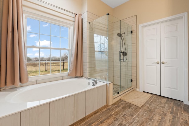 bathroom featuring hardwood / wood-style flooring and separate shower and tub