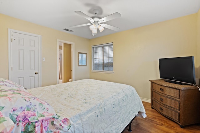 bedroom with dark hardwood / wood-style flooring and ceiling fan