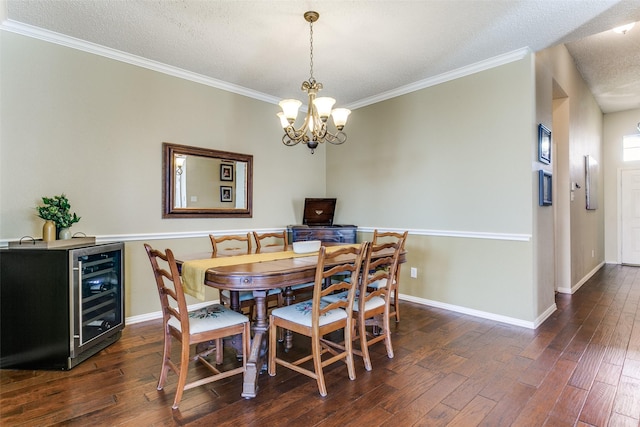 dining area featuring crown molding, dark hardwood / wood-style floors, wine cooler, a textured ceiling, and a chandelier