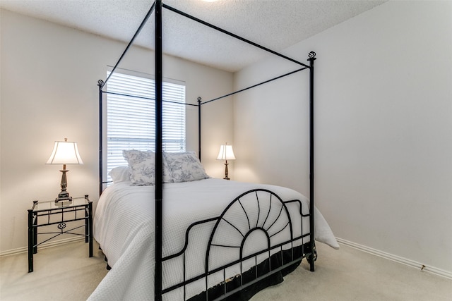 carpeted bedroom featuring a textured ceiling