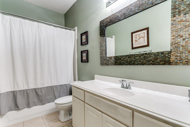 full bathroom featuring vanity, a textured ceiling, tile patterned floors, toilet, and shower / bath combo with shower curtain