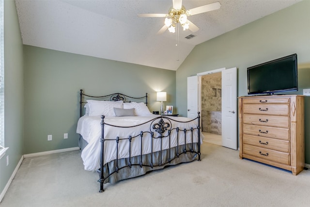 carpeted bedroom with connected bathroom, vaulted ceiling, a textured ceiling, and ceiling fan