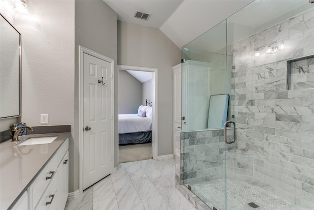 bathroom featuring lofted ceiling, vanity, and a shower with shower door