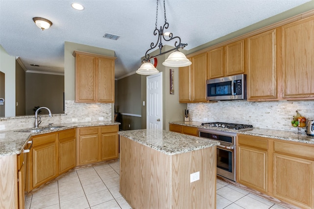 kitchen with sink, a kitchen island, hanging light fixtures, and appliances with stainless steel finishes