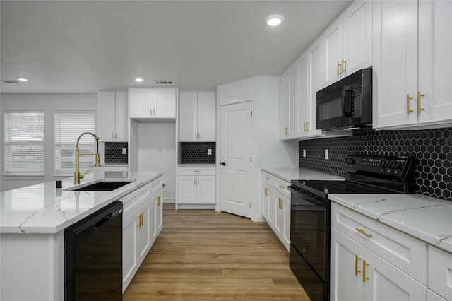 kitchen featuring white cabinets, sink, and black appliances