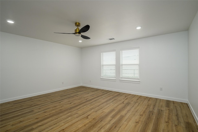 spare room featuring ceiling fan and hardwood / wood-style floors