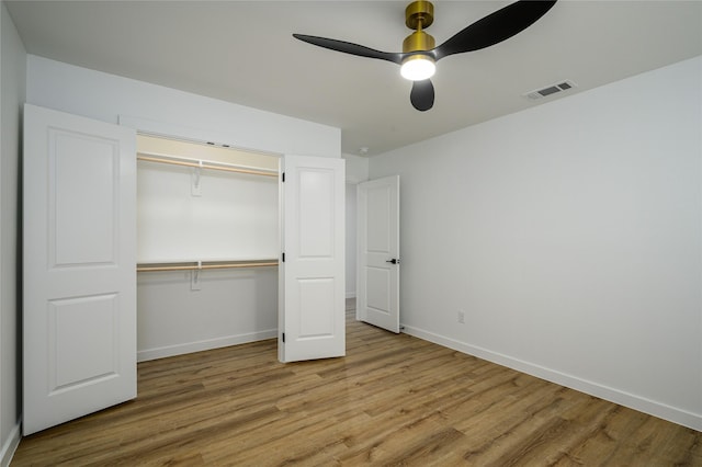 unfurnished bedroom with ceiling fan, light hardwood / wood-style floors, and a closet