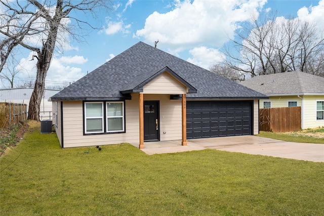 ranch-style house featuring central AC unit, a garage, and a front lawn