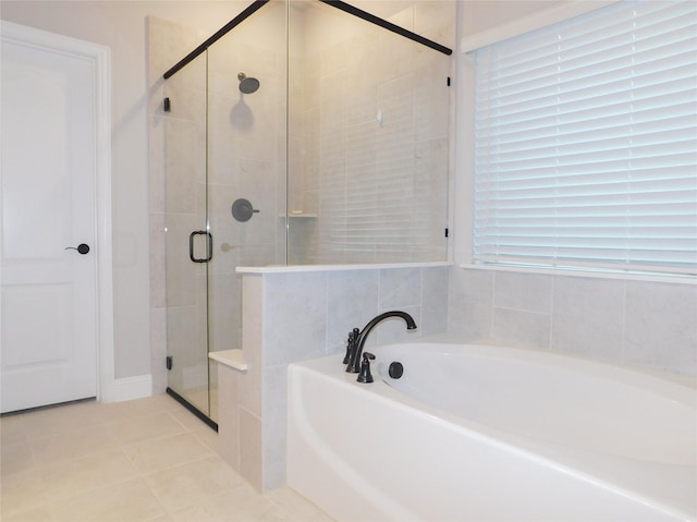 bathroom featuring tile patterned flooring and plus walk in shower