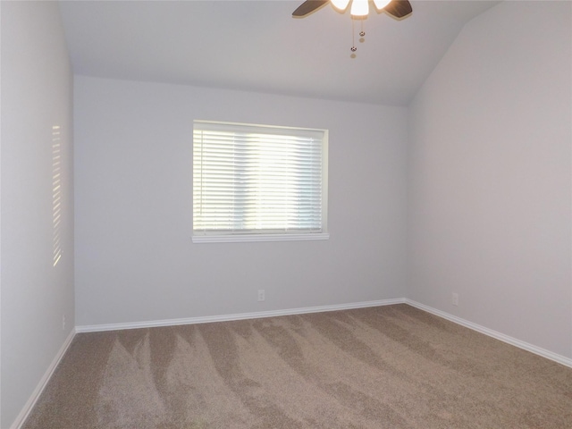 carpeted empty room with vaulted ceiling and ceiling fan