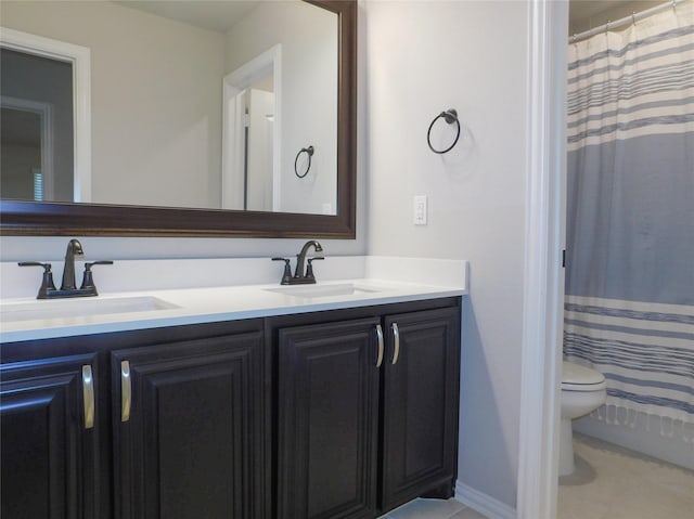 bathroom featuring vanity, curtained shower, tile patterned floors, and toilet